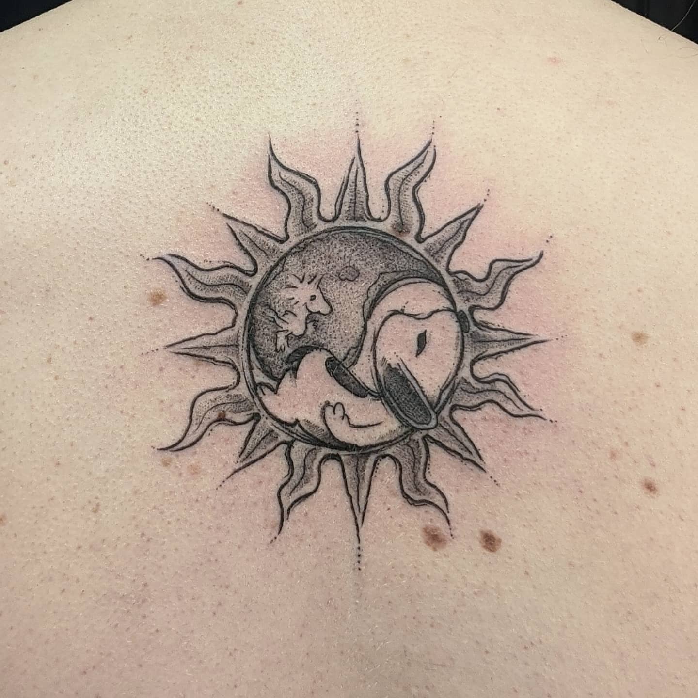 Sun and moon dotwork tattoo on the back by Gail Howard Perry III