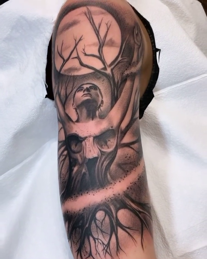 Skull with antlers and a figure dark realism tattoo by BJ