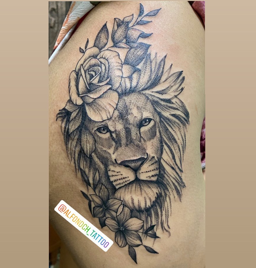 Lion with floral crown dotwork tattoo on the thigh by Alfonso Duenas