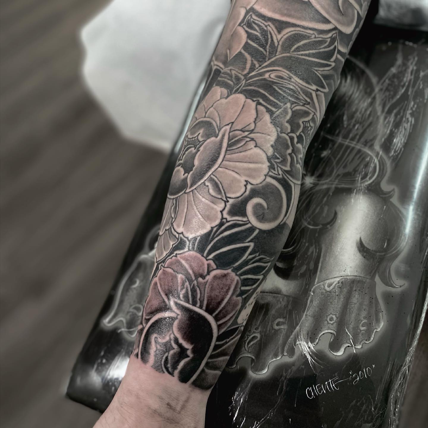 Floral design black and grey tattoo on the forearm by Daniel Gutierrez