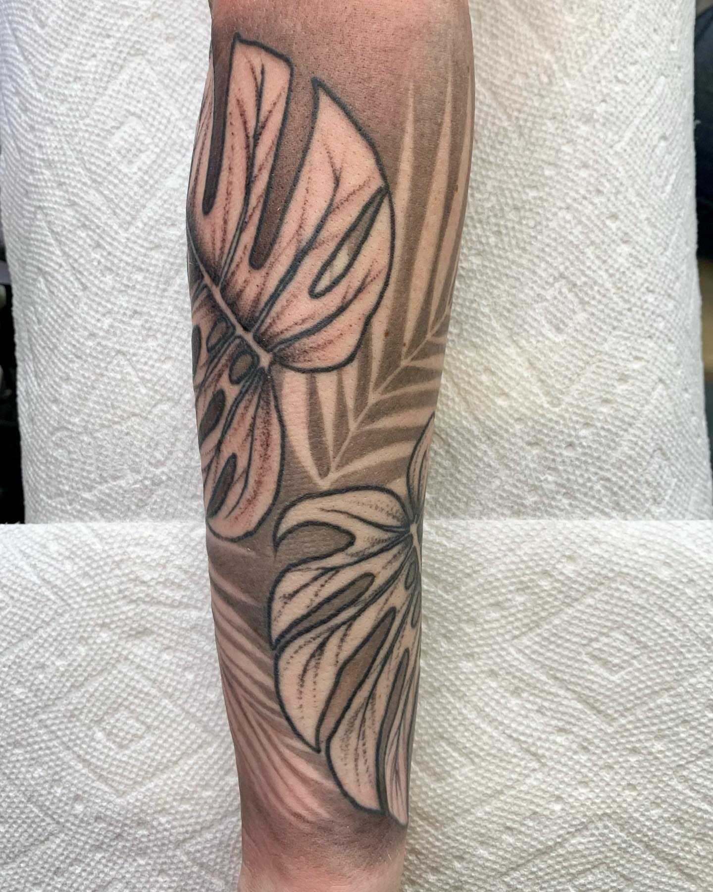 Monstera leaves black and grey tattoo on the forearm by The Tattoo Saint- DMV Tattoo Artist, Hyattsville, Maryland
