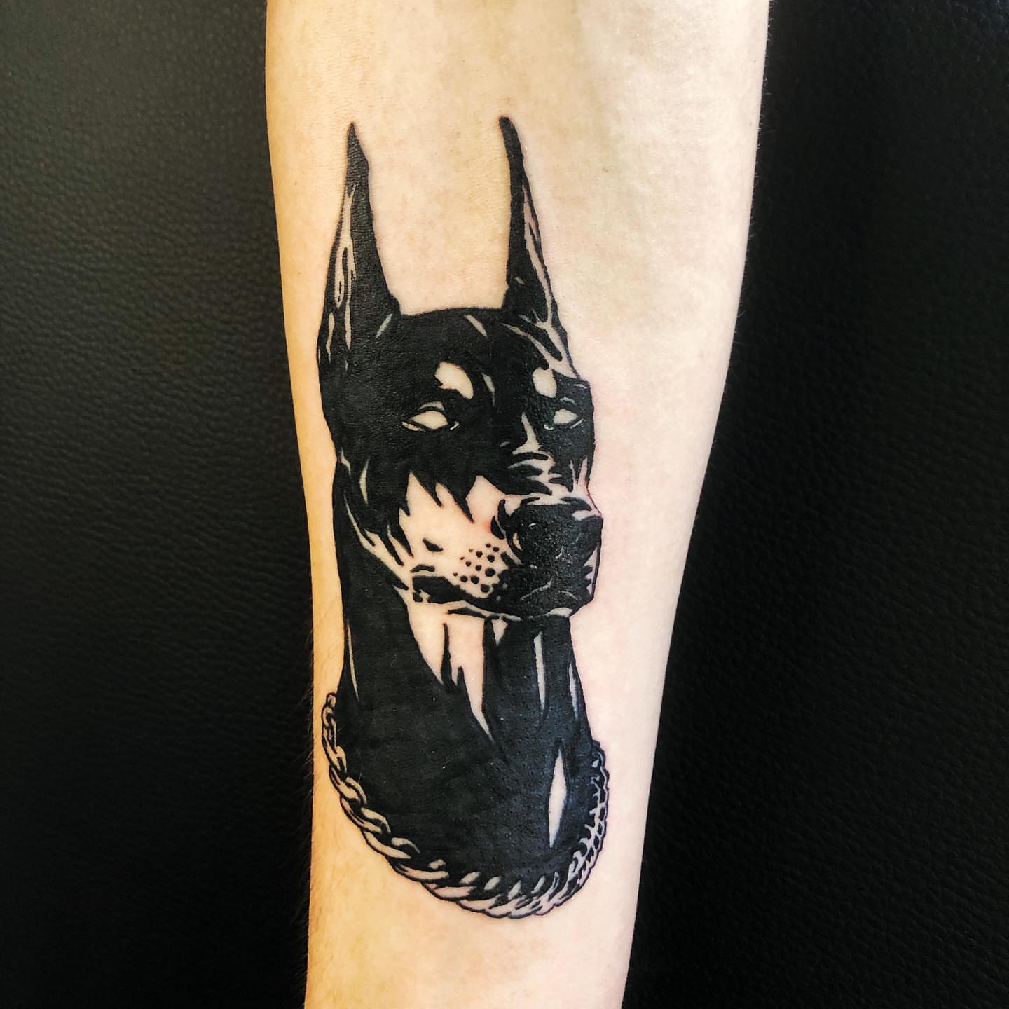 Dog head black and grey tattoo on the forearm by NYC