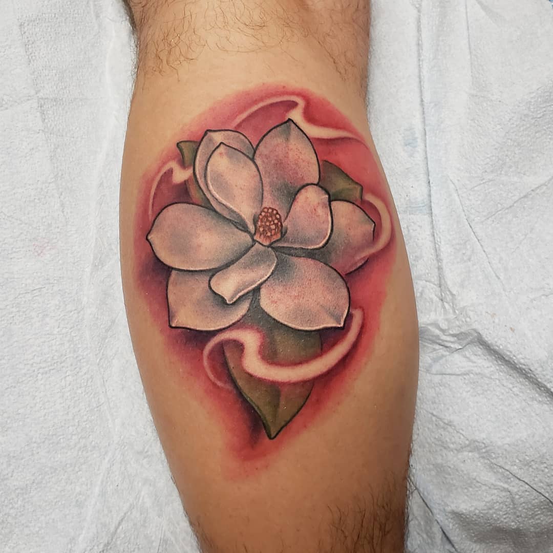 Magnolia flower realism tattoo on the forearm by Don Taylor