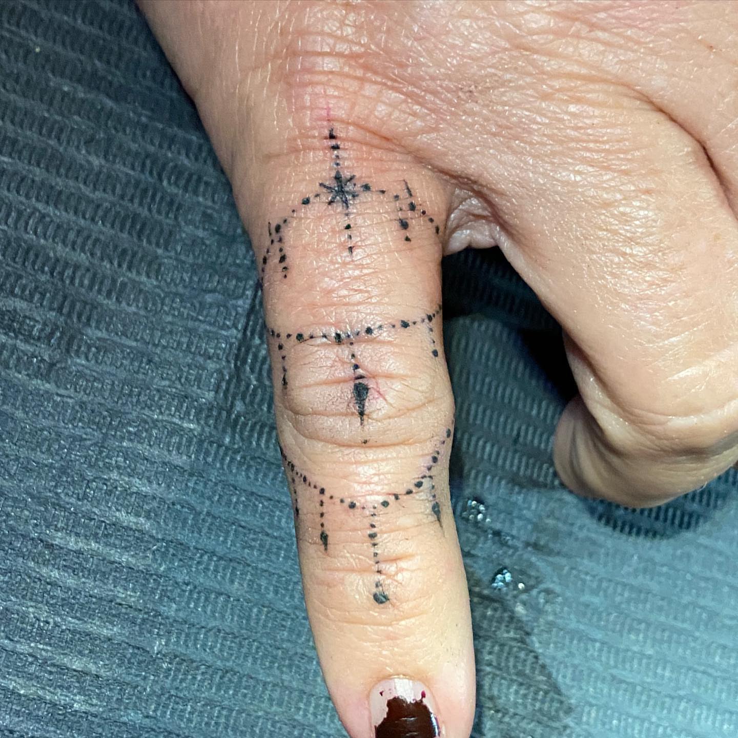 Geometric design dotwork tattoo on the hand by Nick