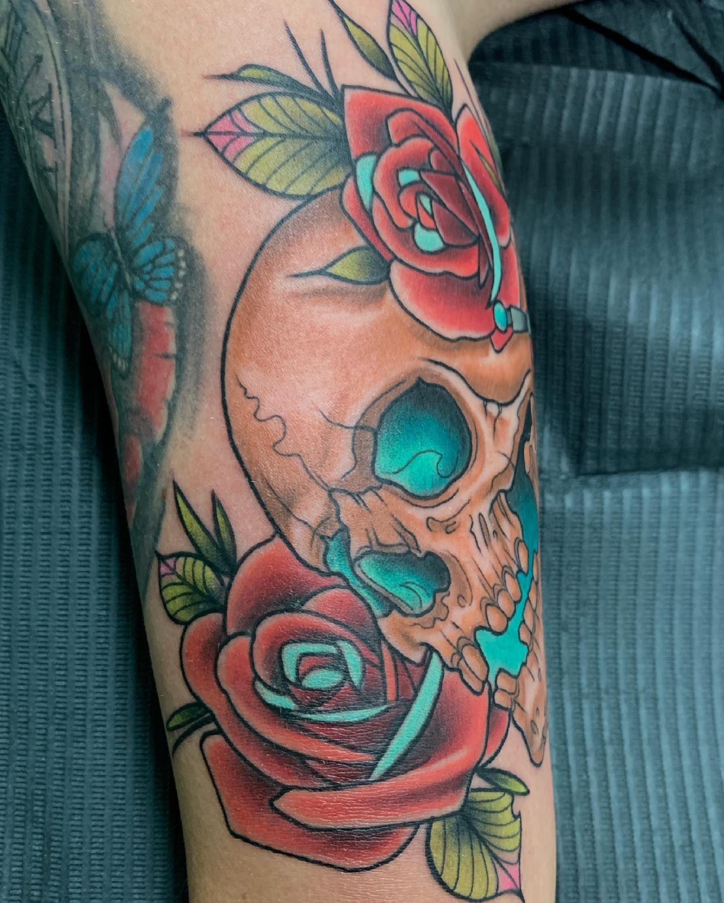 Skull and roses American traditional tattoo on the forearm by Erick Campion