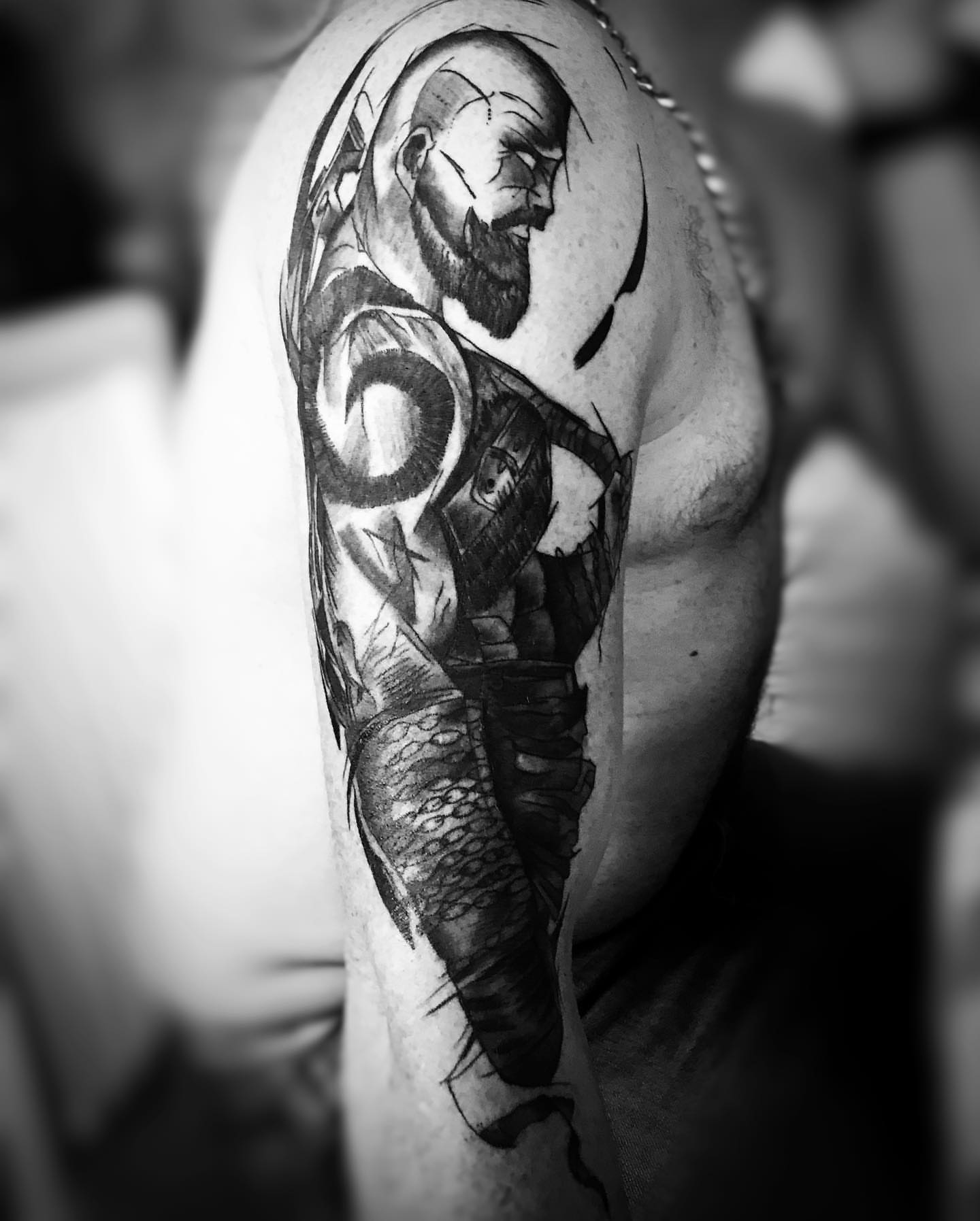 Bearded warrior realism tattoo on the upper arm by Iryna Polyakhova