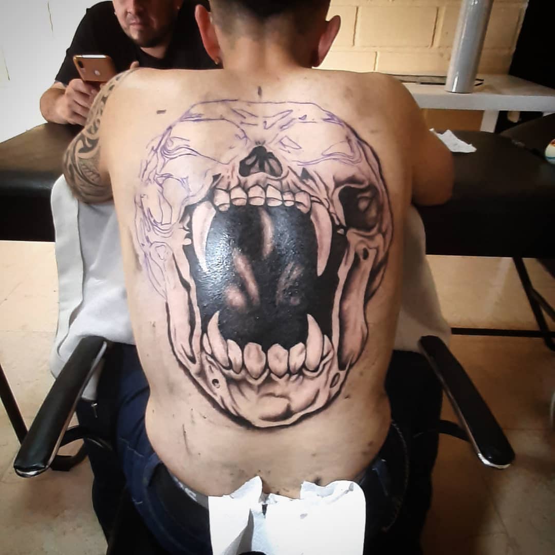 Skull realism tattoo on the back by Erasmo Vasquez