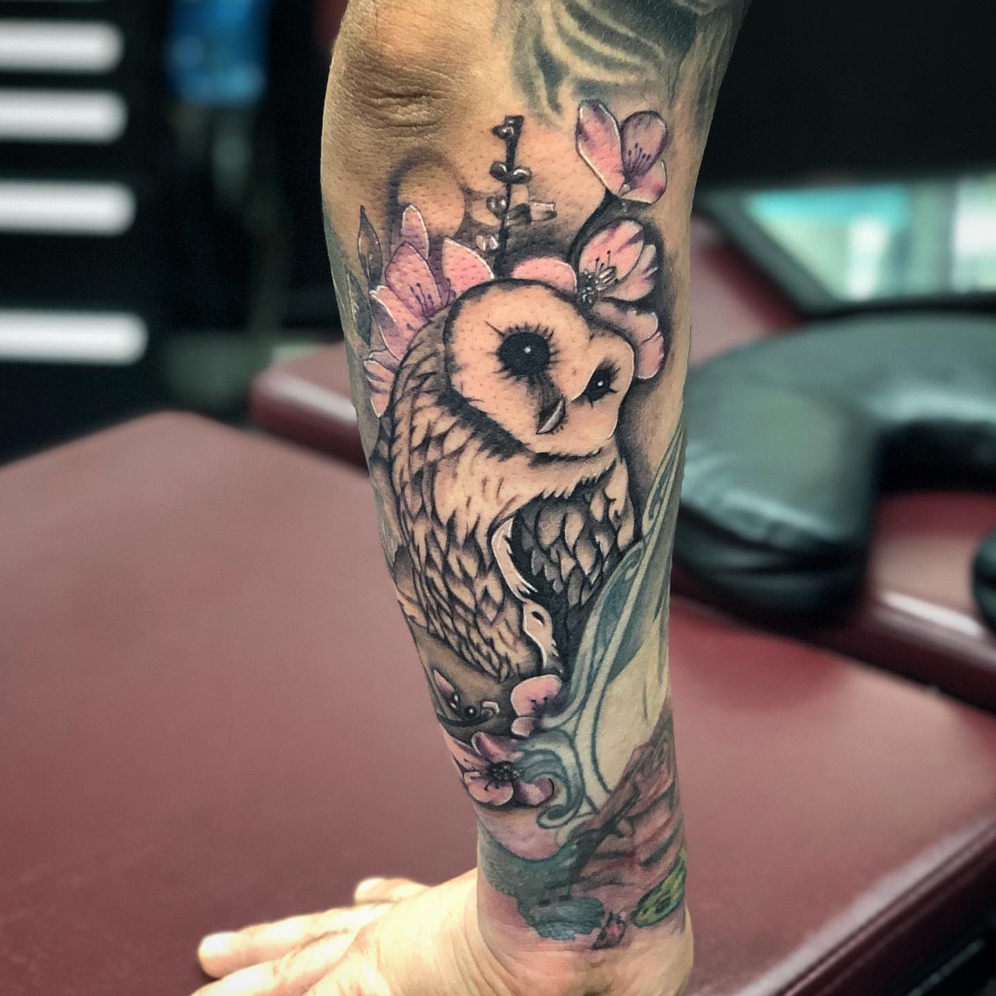 Owl with flowers black and grey tattoo on the forearm by Tattoos by Rey G.
