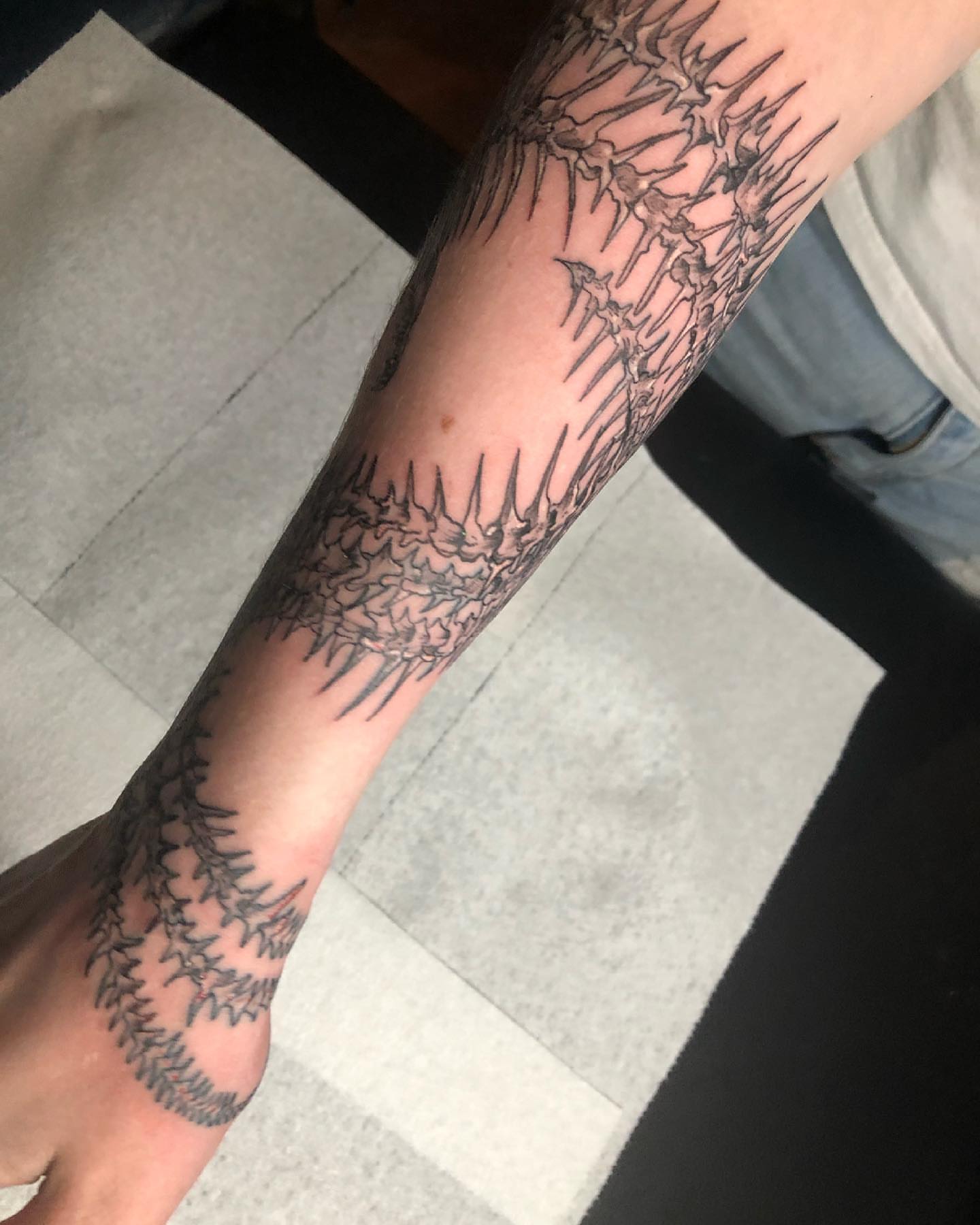 Thorns black and grey tattoo on the forearm by Dre Inks