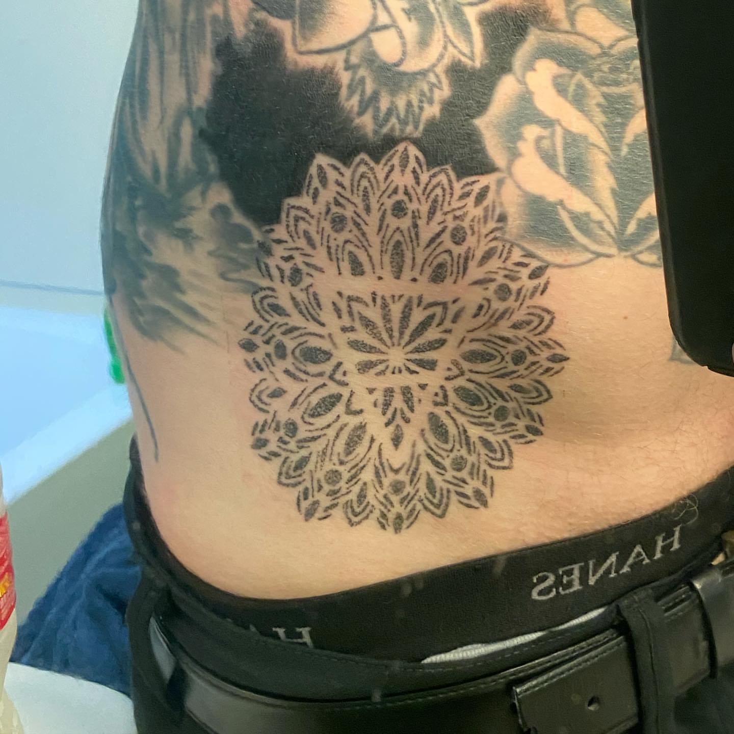Mandala geometric tattoo on the torso by Nicholas Jones