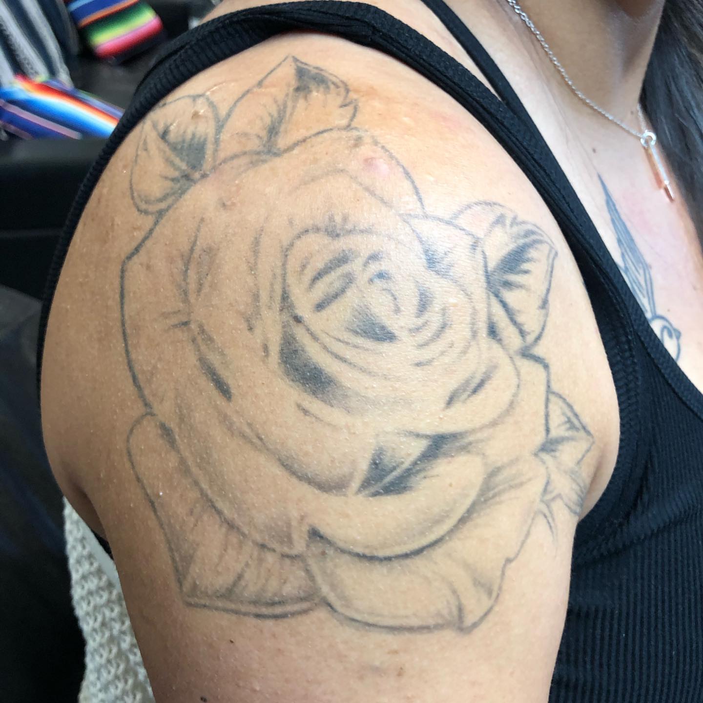 Rose black and grey tattoo on the shoulder by Leslie Preciado