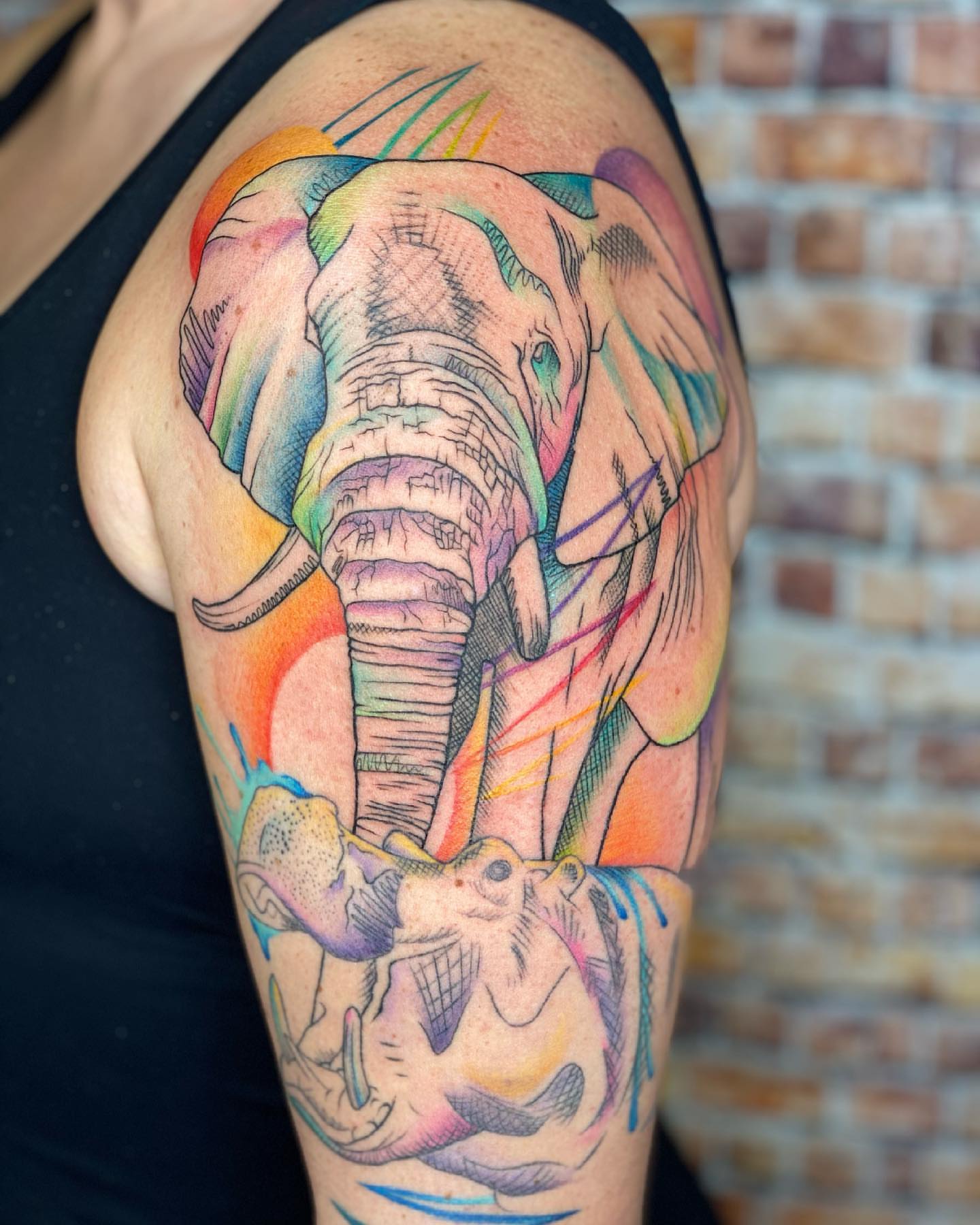 Elephant watercolor tattoo on the upper arm by Tattoos by Hanna, Farmington Hills, Michigan