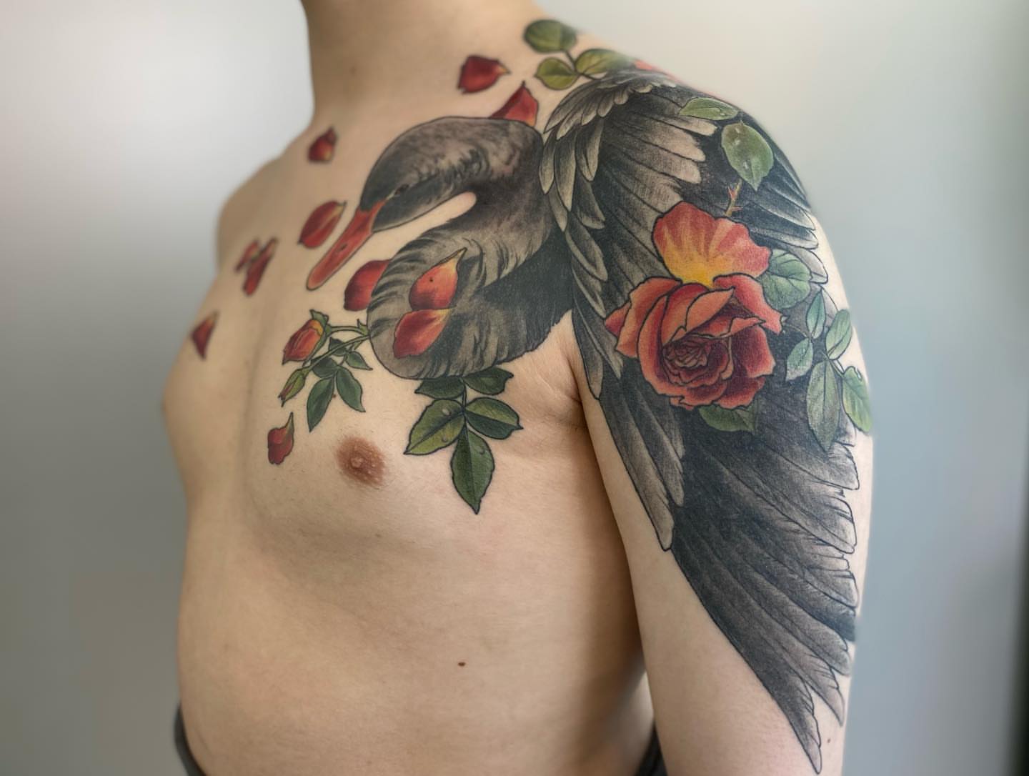 Swan and roses American traditional tattoo on the shoulder by Rusty Indigo