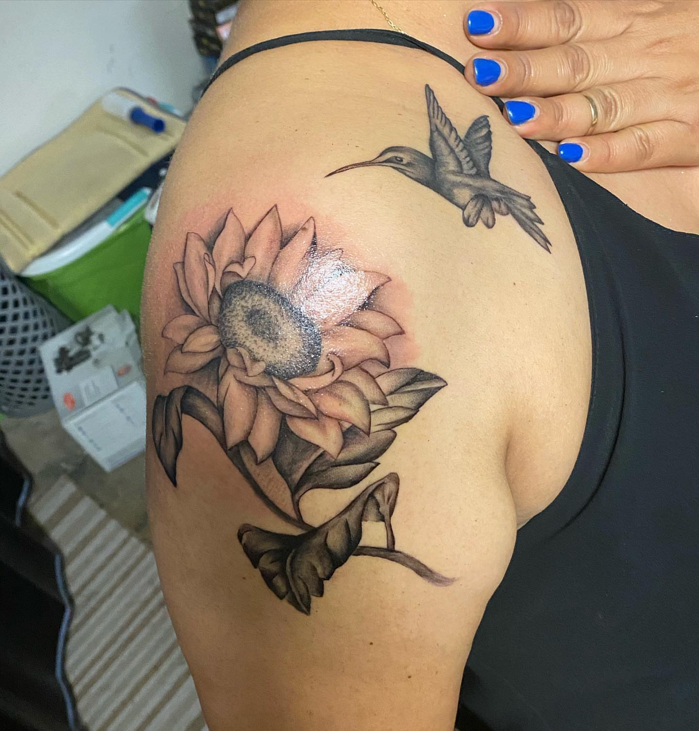 Sunflower and hummingbird realism tattoo on the shoulder by Cesar Nava