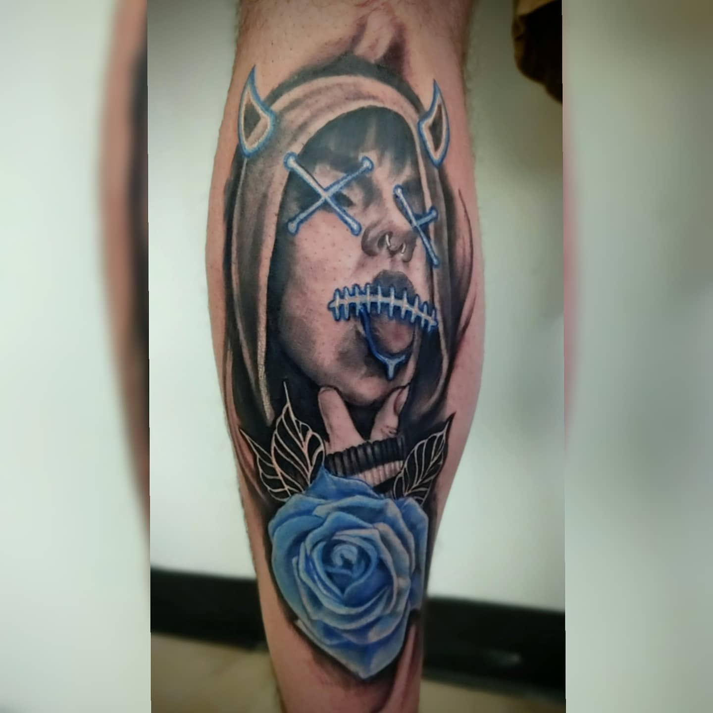 Woman with blue rose realism tattoo on the forearm by Tyler Cromwell