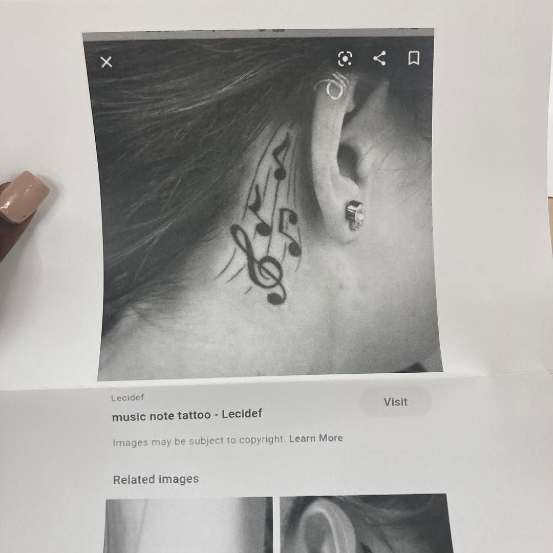 Musical notes tattoo on the neck by Danimals