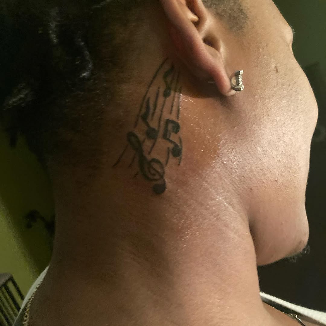 Musical notes tattoo on the neck by Danimals