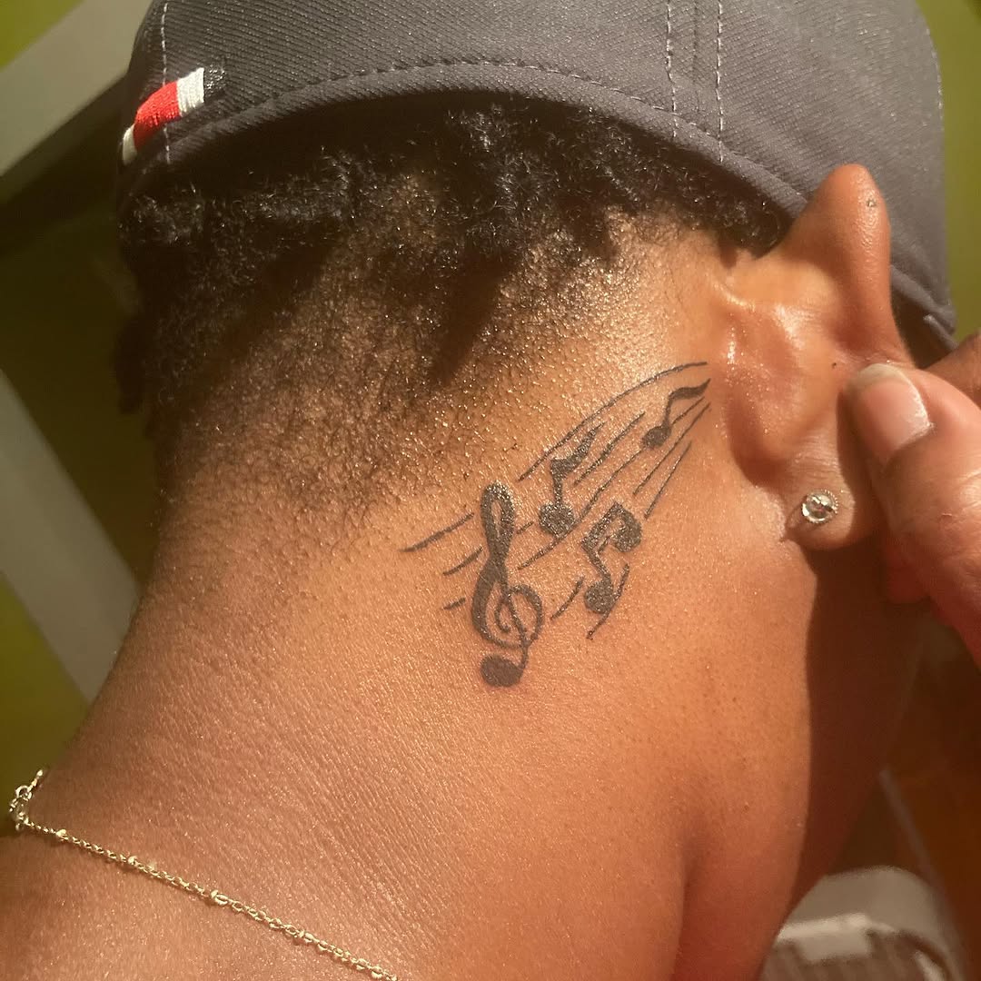 Musical notes tattoo on the neck by Danimals