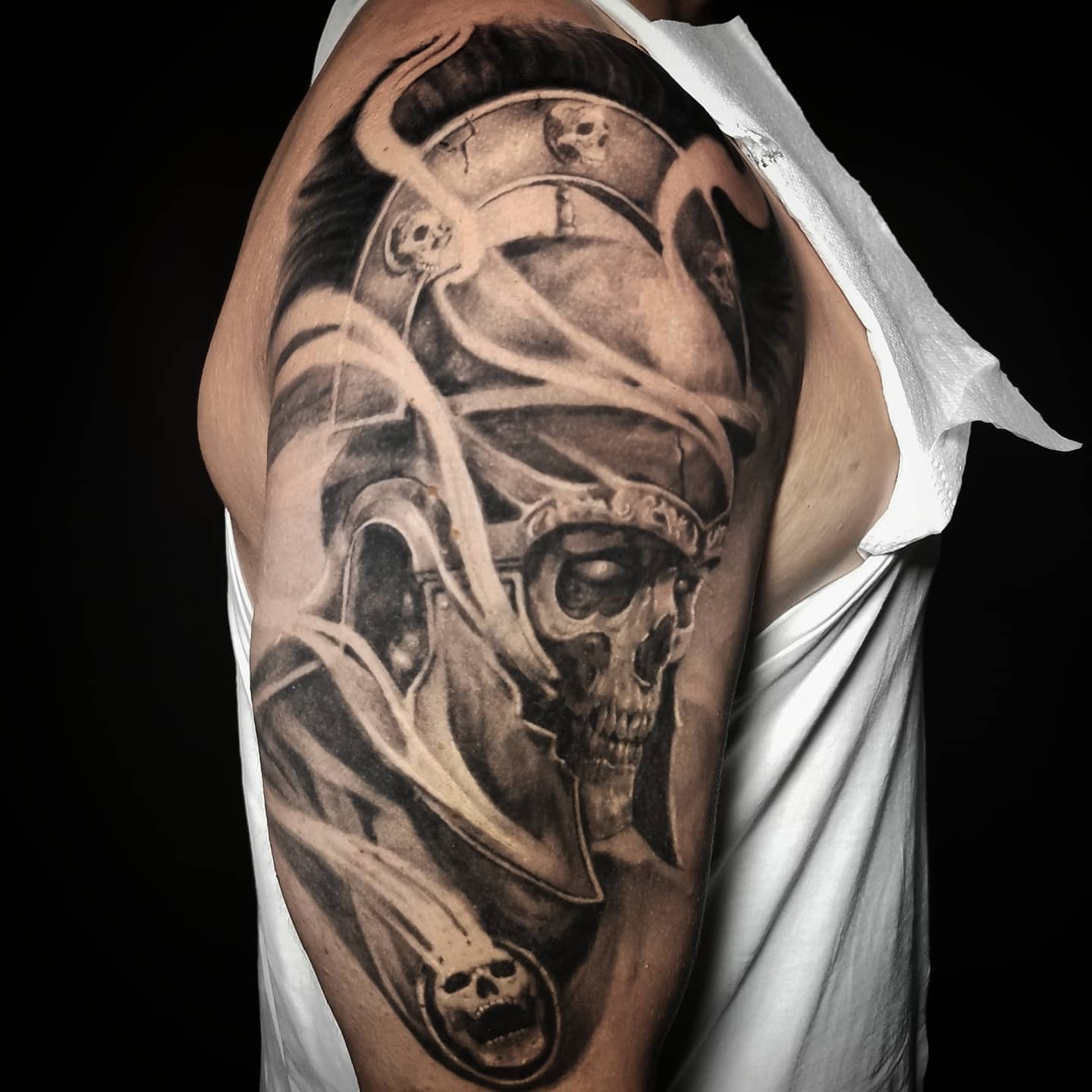 Skull and wings realism tattoo on the upper arm by Lindsay