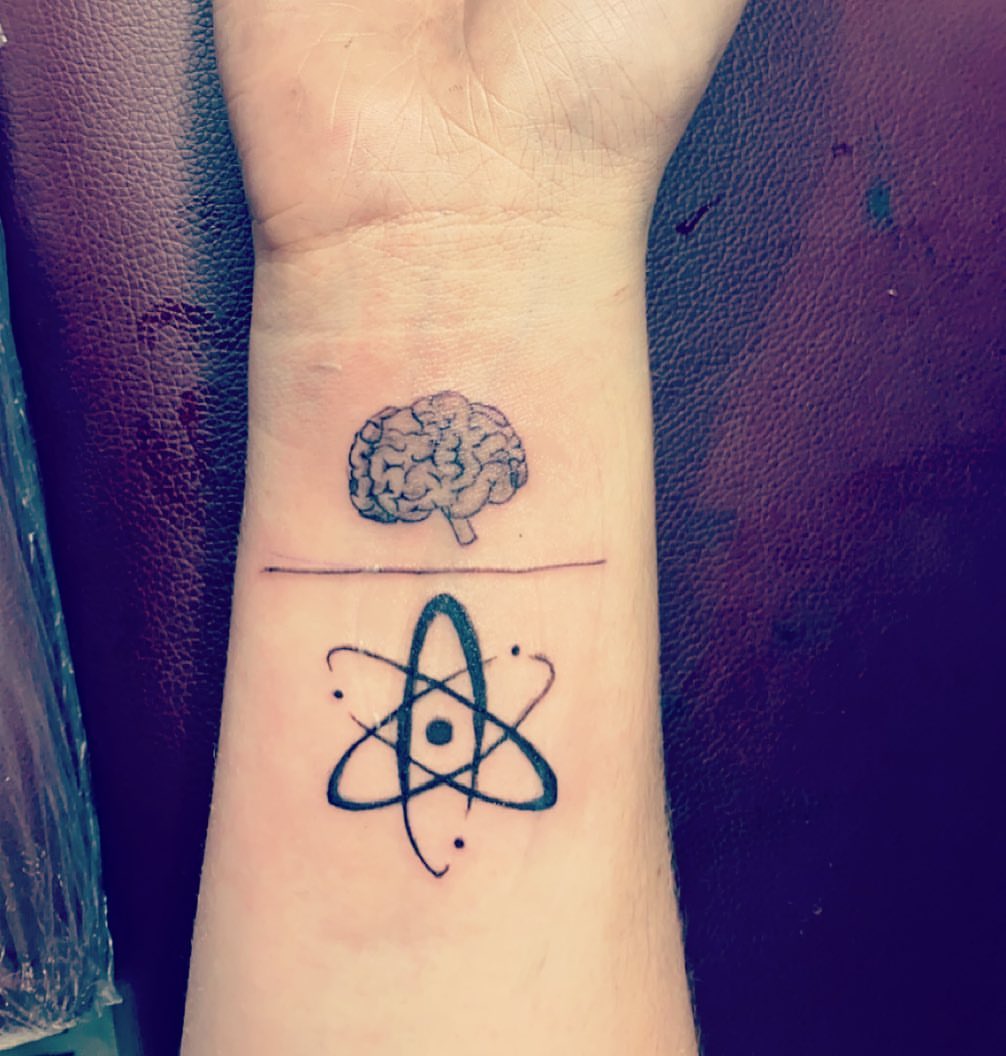 Brain and atom geometric tattoo on the forearm by Daniel Monyongo