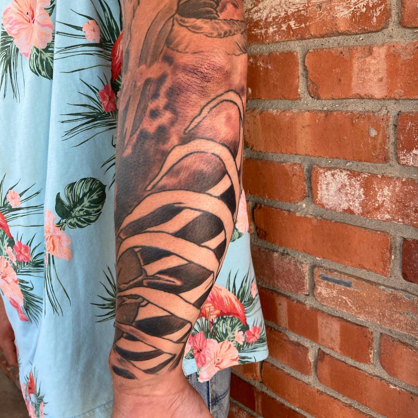 Striped bandages black and grey tattoo on the forearm by Chuck House
