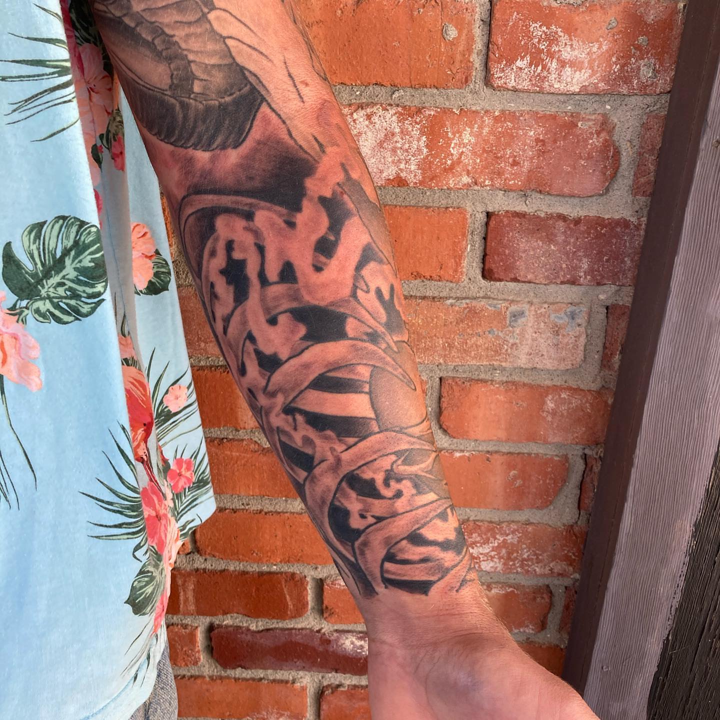 Abstract design black and grey tattoo on the forearm by Chuck House