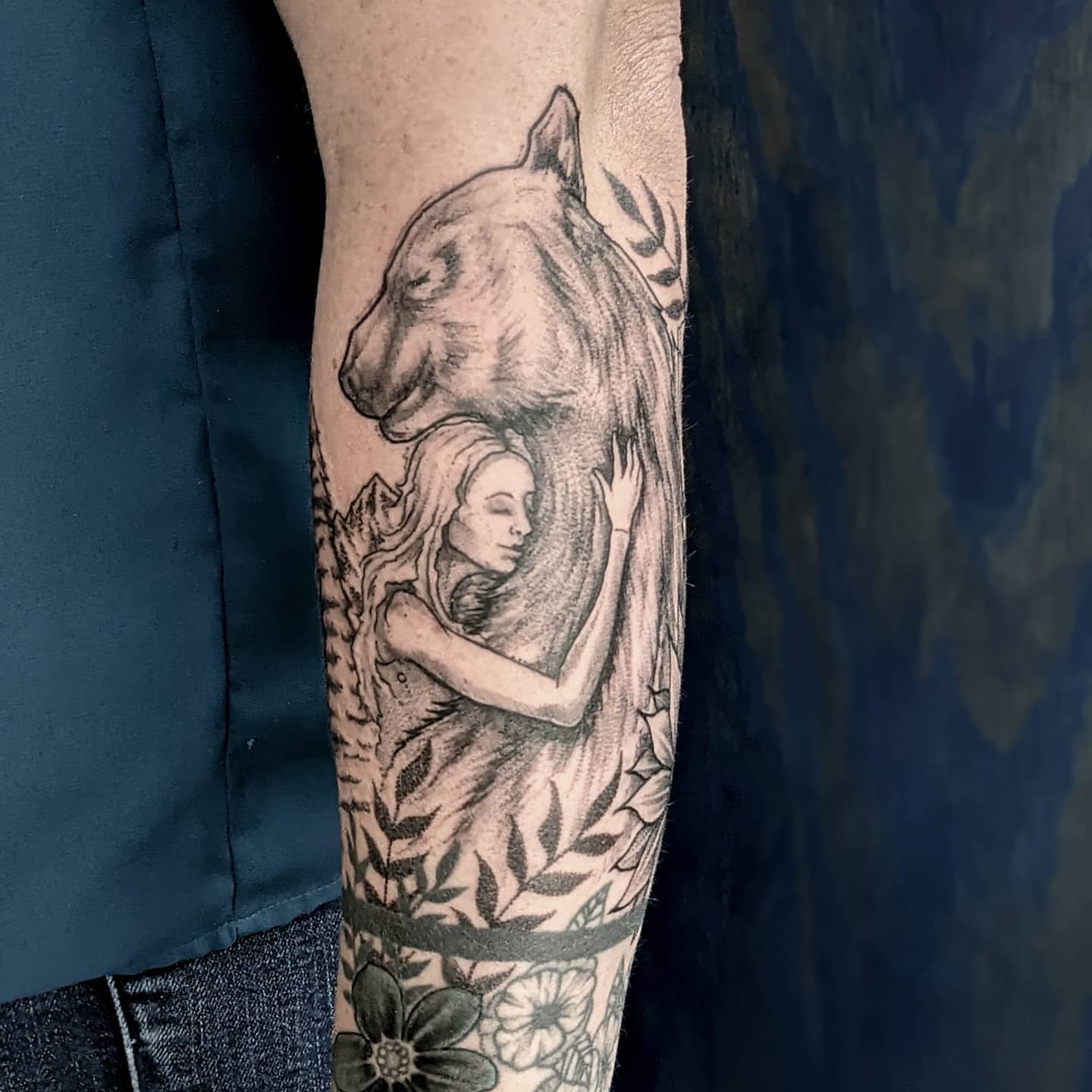 Woman and bear realism tattoo on the forearm by Gail Howard Perry III
