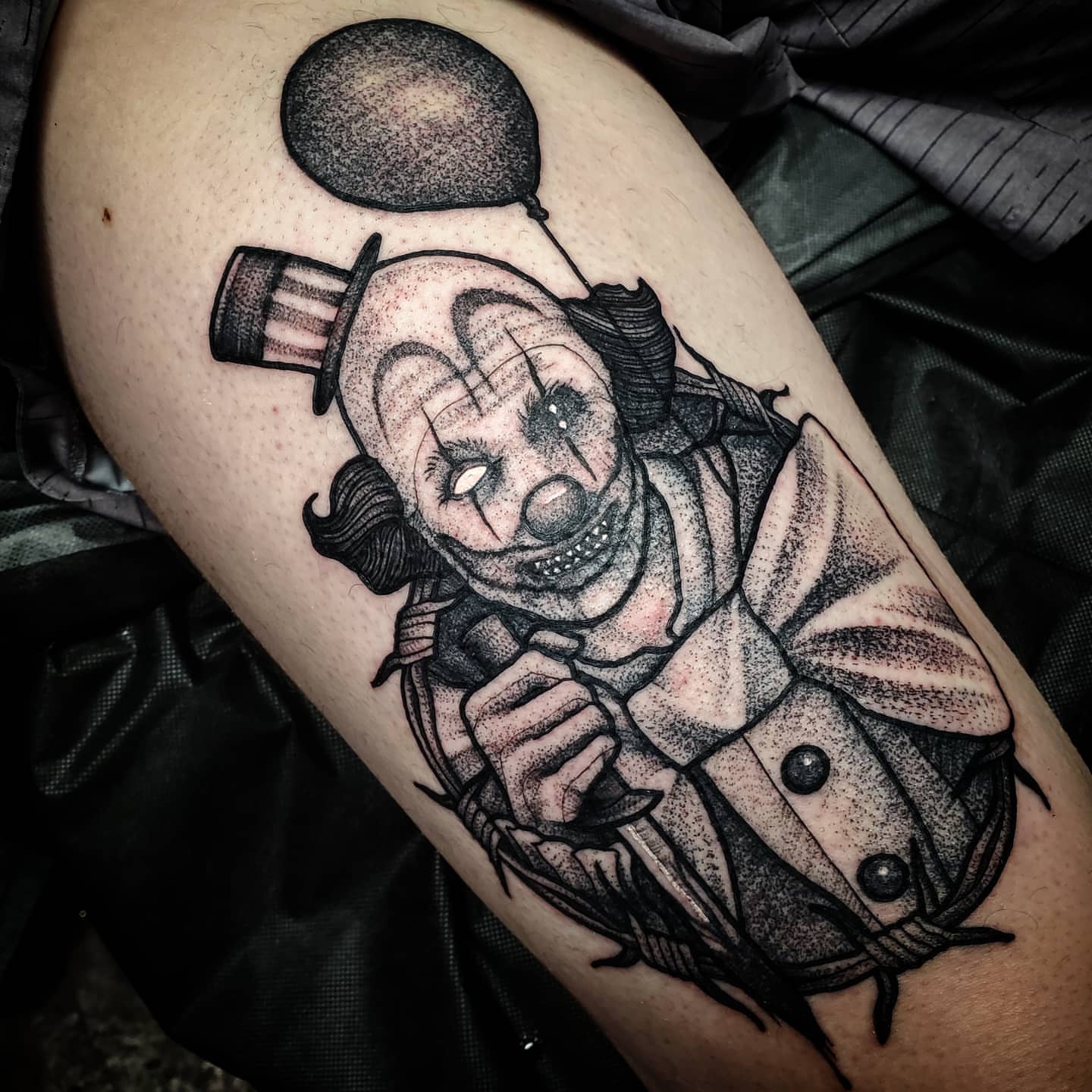 Clown dotwork tattoo on the thigh by Kyle Black