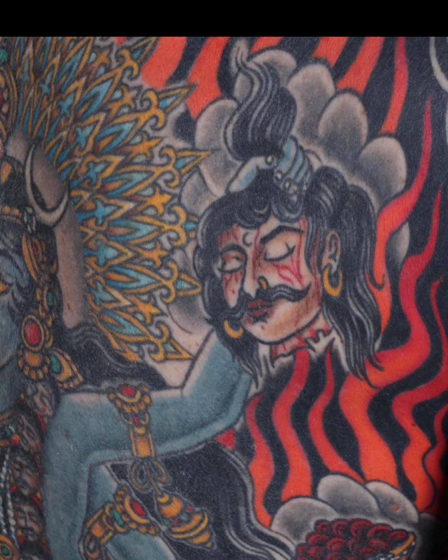 Deity with flames American traditional tattoo by Haley McMahon