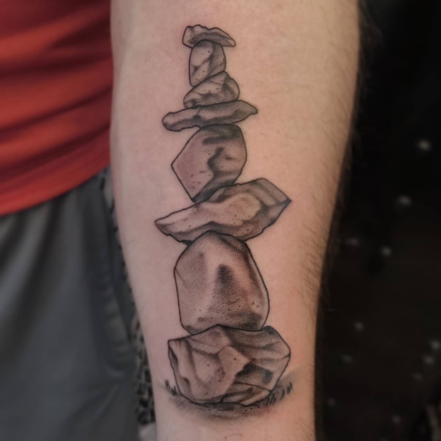 Stacked stones black and grey tattoo on the forearm by Neri Gersaint