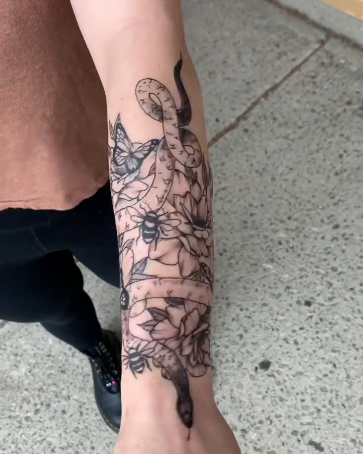 Snake and flowers with Roman numerals realism tattoo by Megan McKee Tattoo Artist