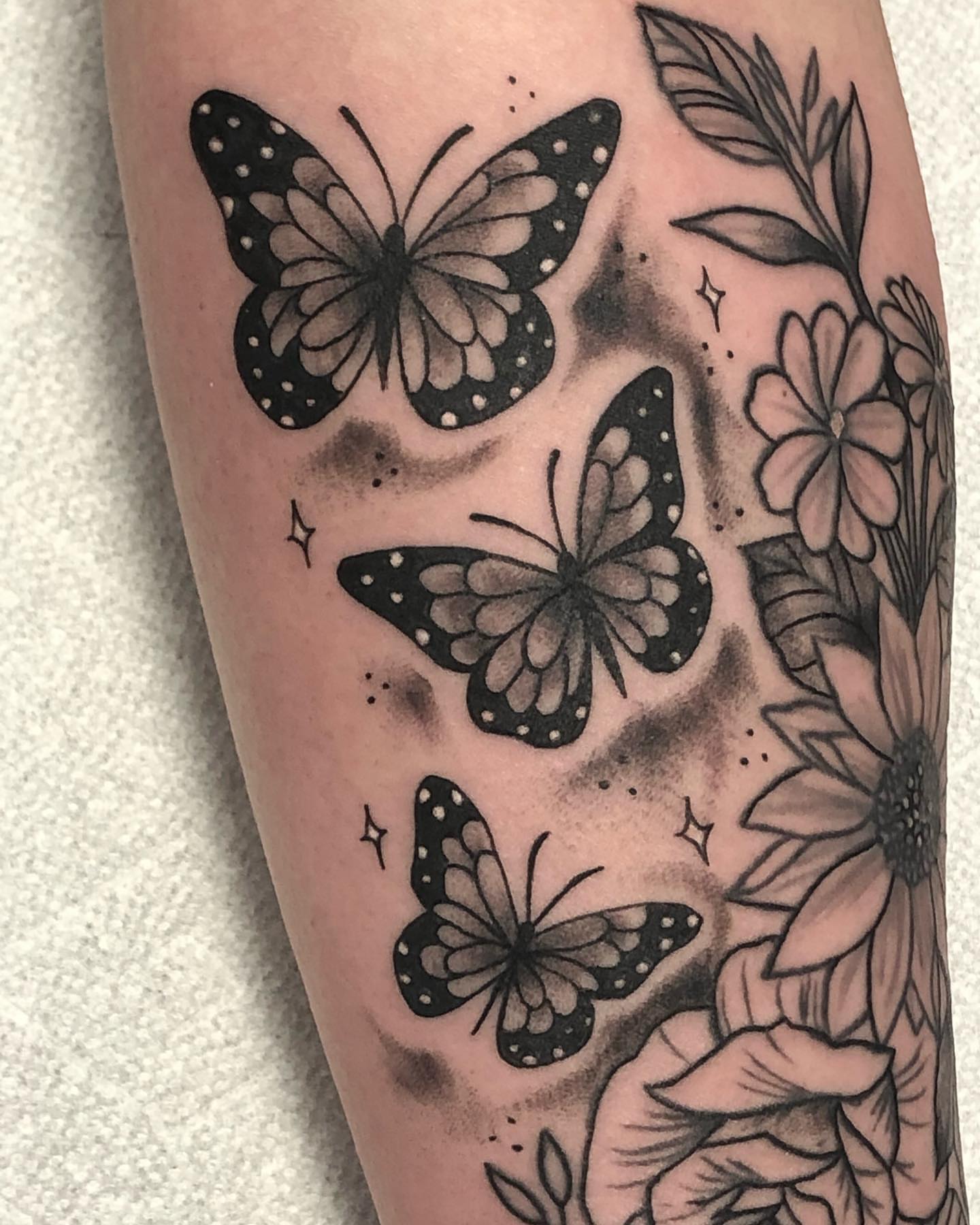 Butterflies and flowers dotwork tattoo on the forearm by Strange Brew Tattoo