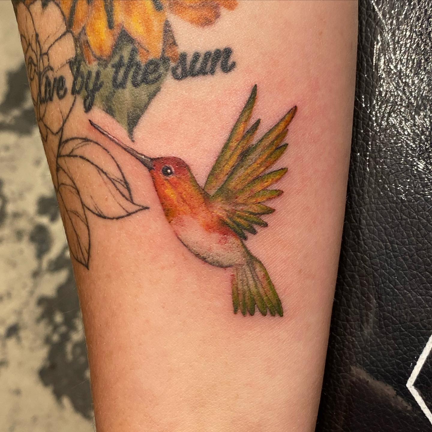 Hummingbird realism tattoo on the forearm by Emily Conner