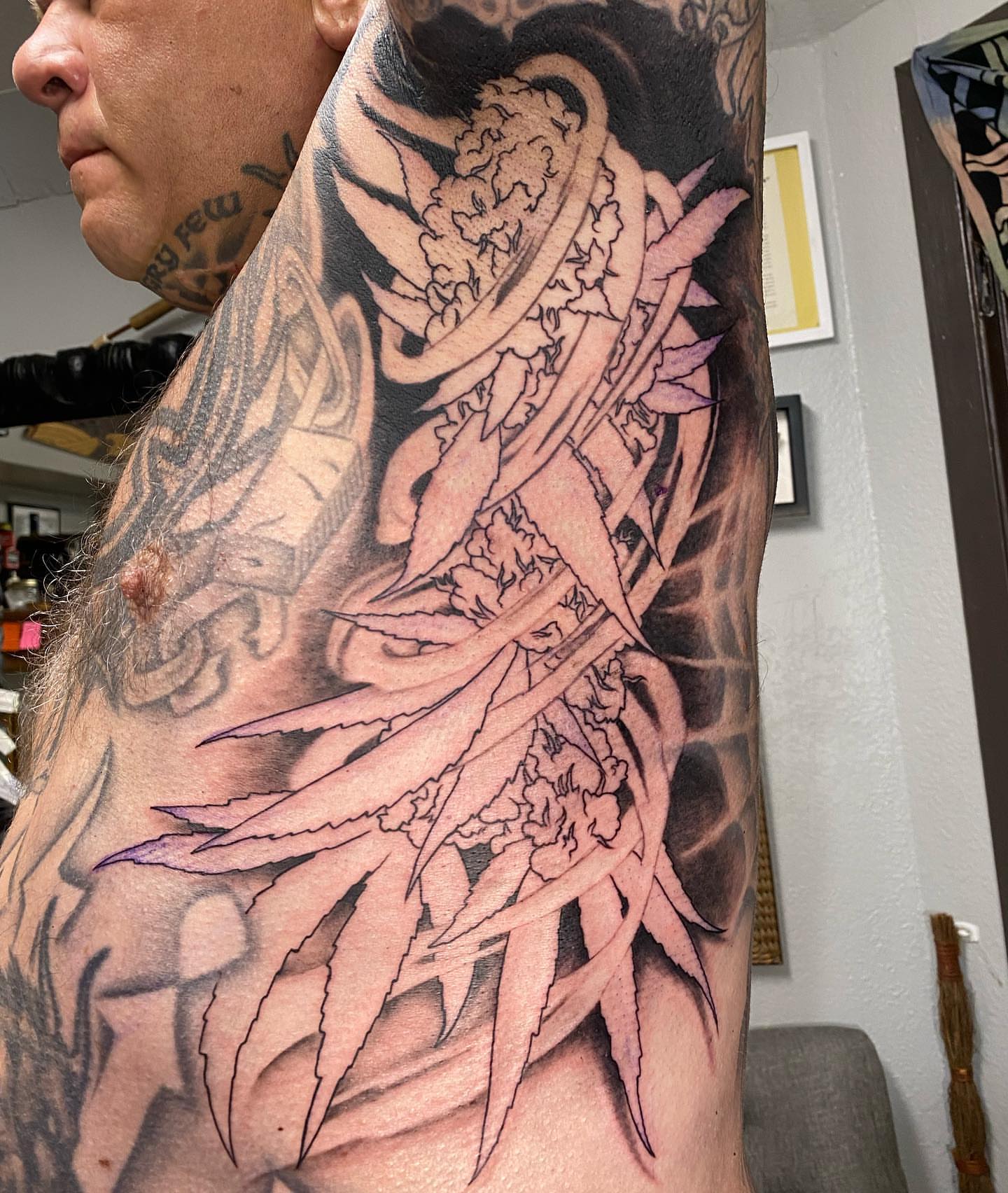Marijuana plant realism tattoo on the upper arm by Dustin Lane Collins