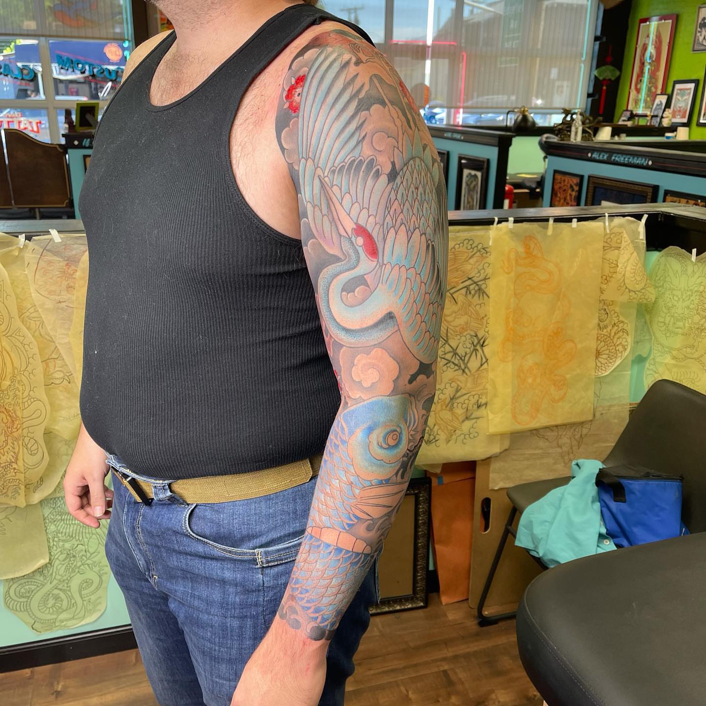 Crane and clouds japanese irezumi tattoo on the upper arm by Mark Thompson, Dallas, Texas