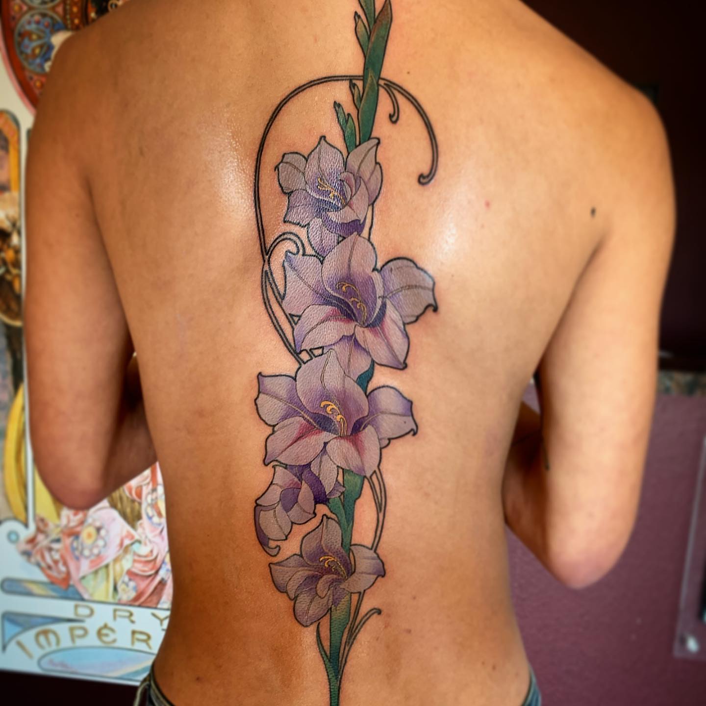 Gladiolus flowers realism tattoo on the back by Jeff Norton, Atascadero, California