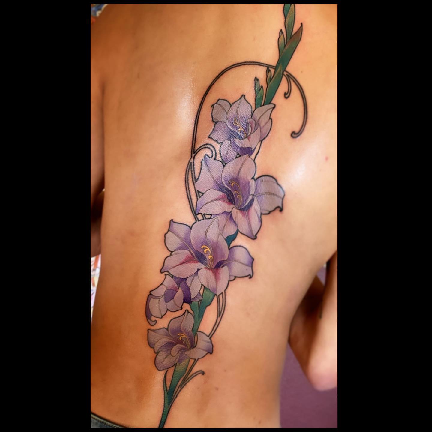 Gladiolus flowers realism tattoo by Jeff Norton, Atascadero, California