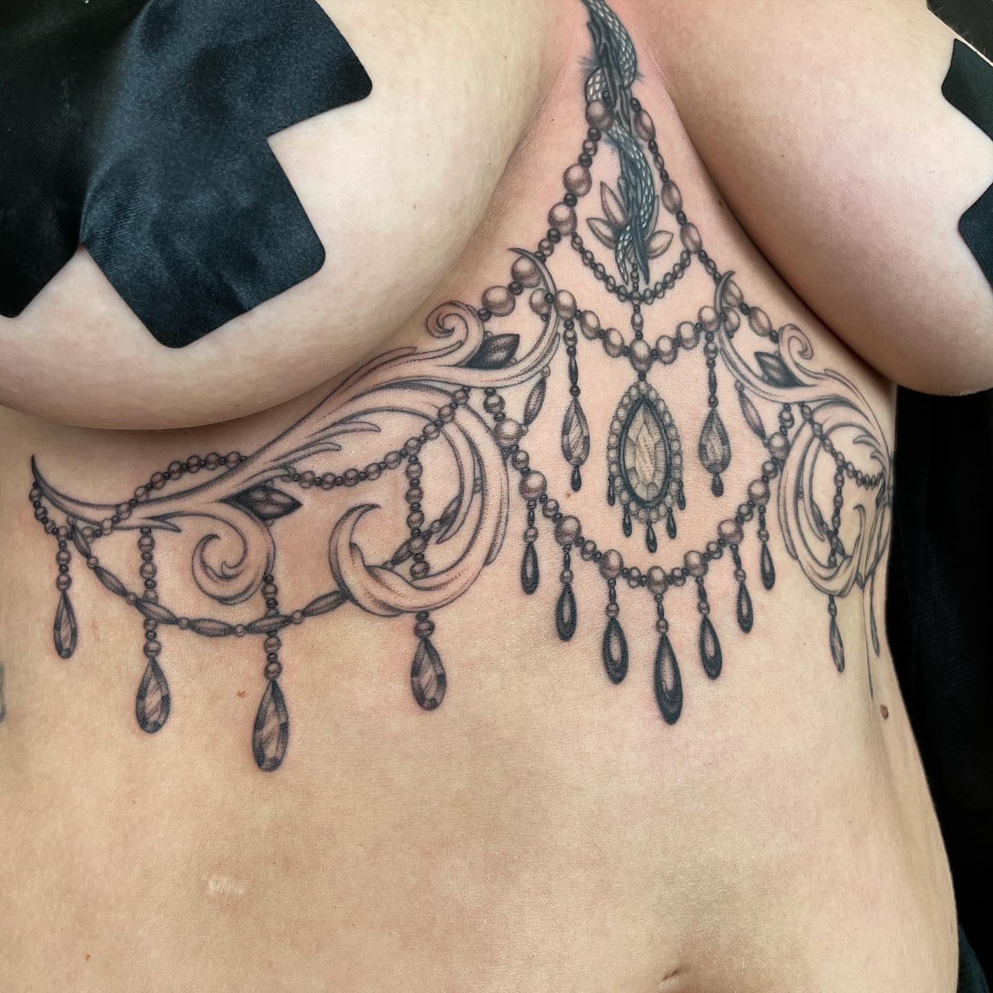Chandelier ornamental tattoo on the chest by @jettaturas, New City, New York