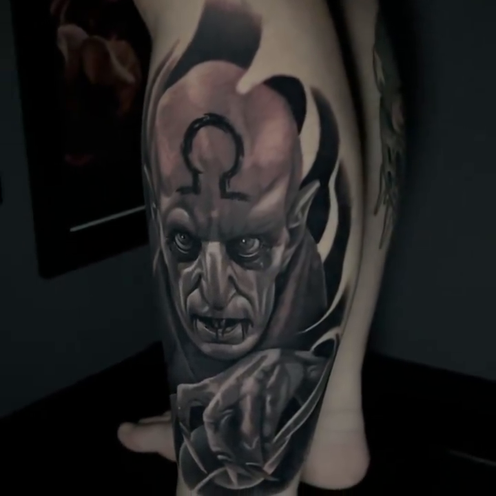 Demonic figure with omega symbol dark realism tattoo by Travis Chick