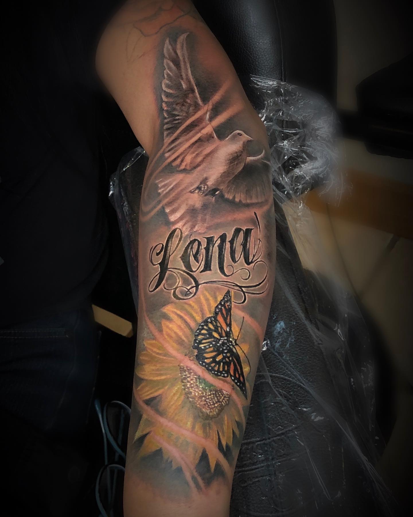 Sunflower and butterfly realism tattoo on the forearm by Levi Tattoo Artist, Utah