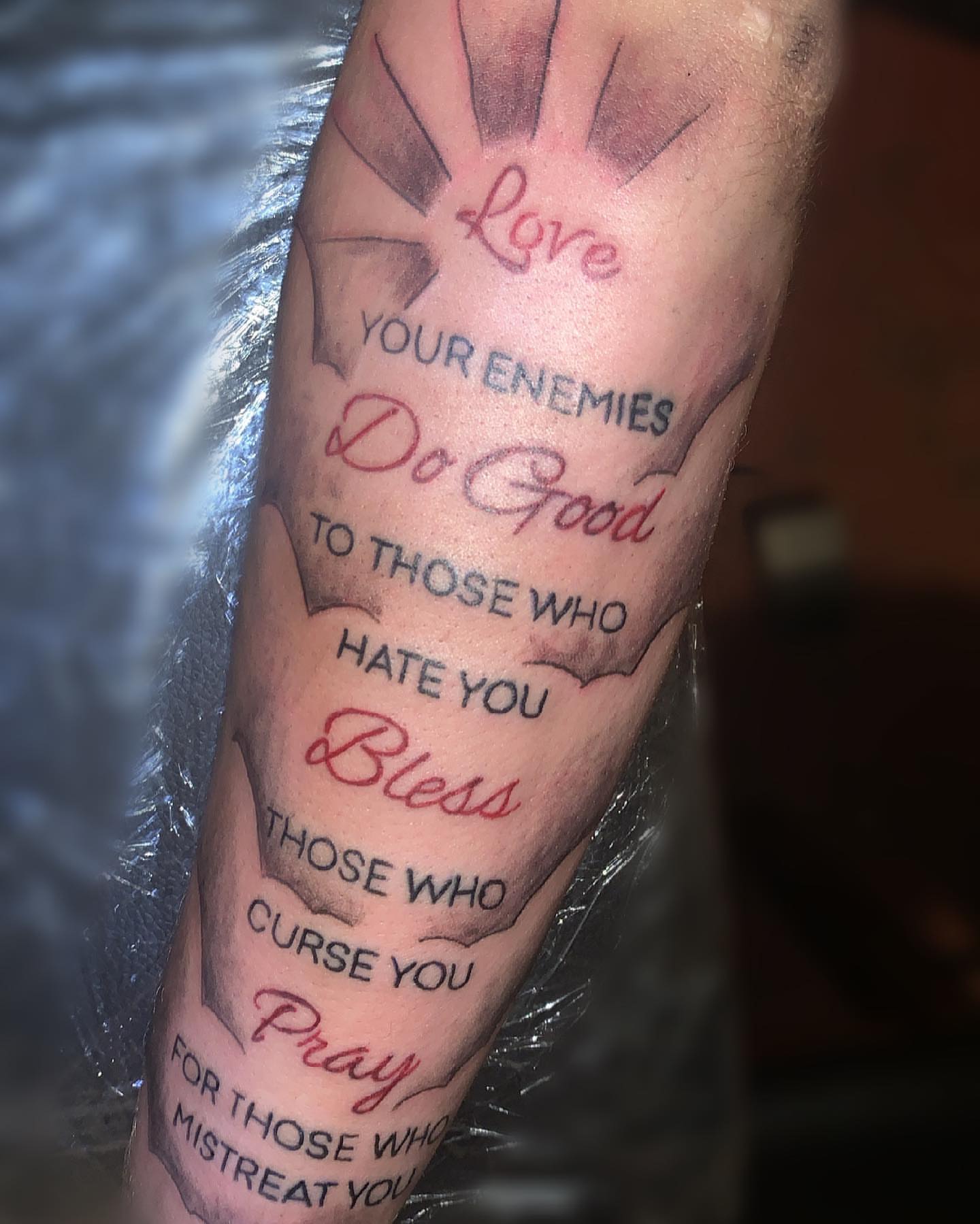 Love, do good, bless, pray lettering script tattoo on the forearm by groovyyinkss