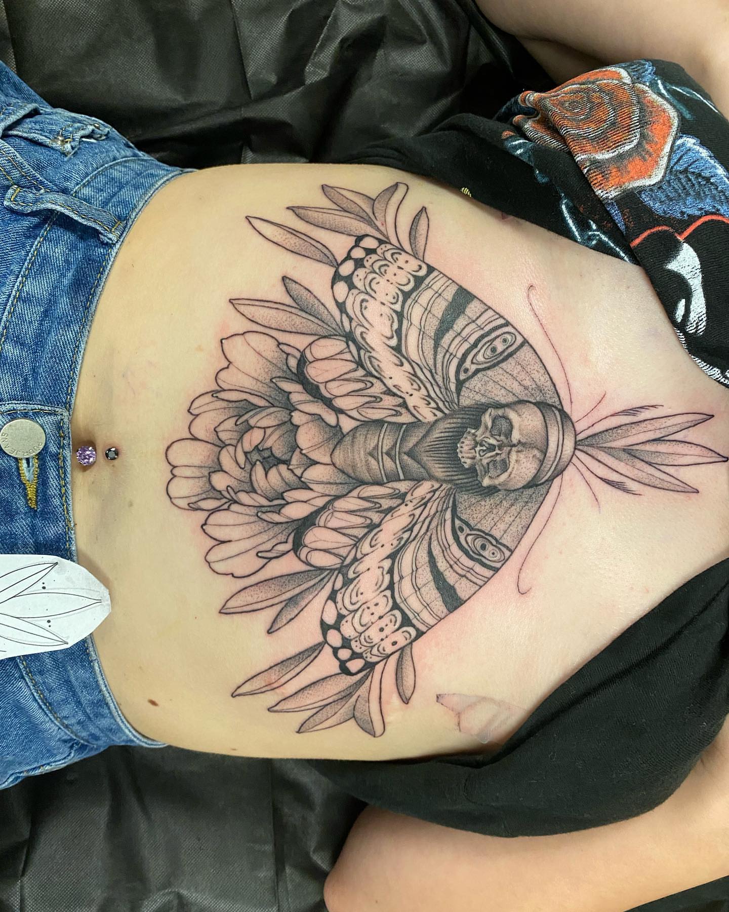 Skull with floral mandala geometric tattoo on the ribs by Valen Laska