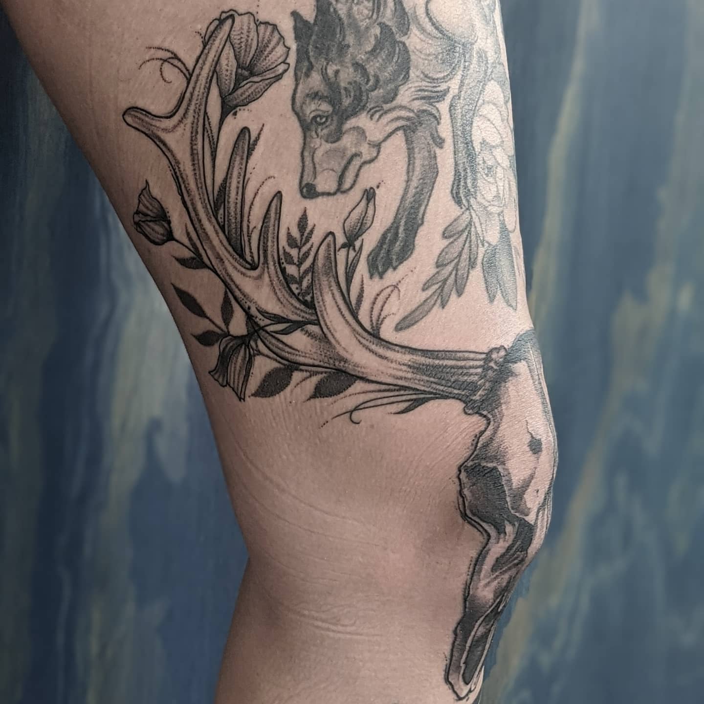Antlers and wolf realism tattoo on the forearm by Gail Howard Perry III