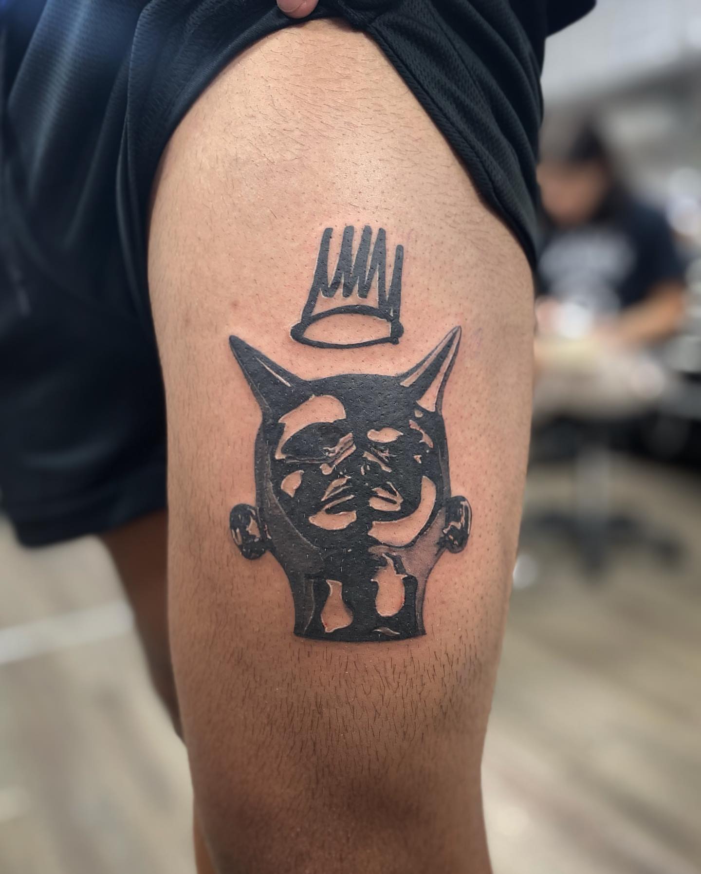 Cat with crown black and grey tattoo on the thigh by Mia