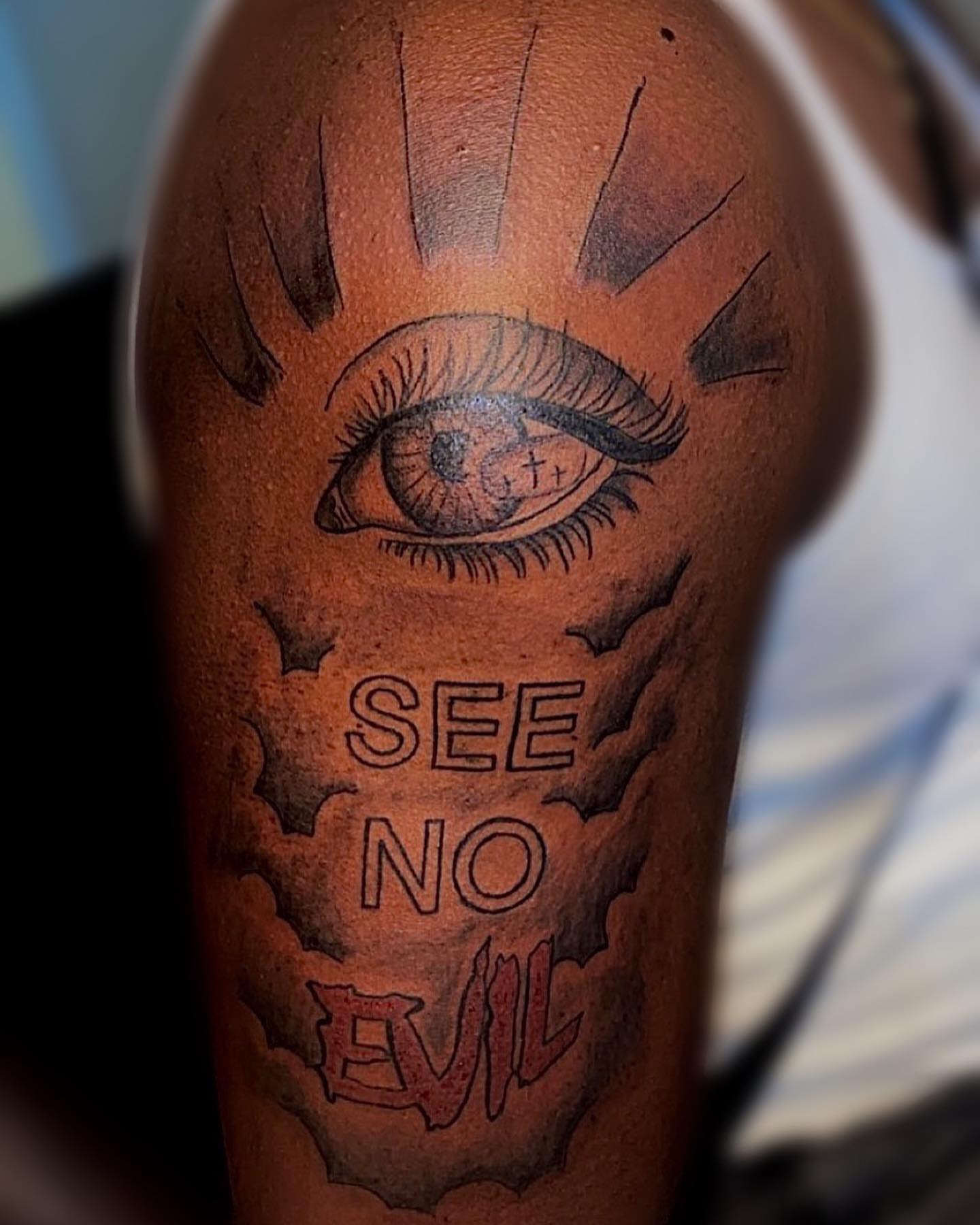 Eye black and grey tattoo on the forearm by groovyyinkss