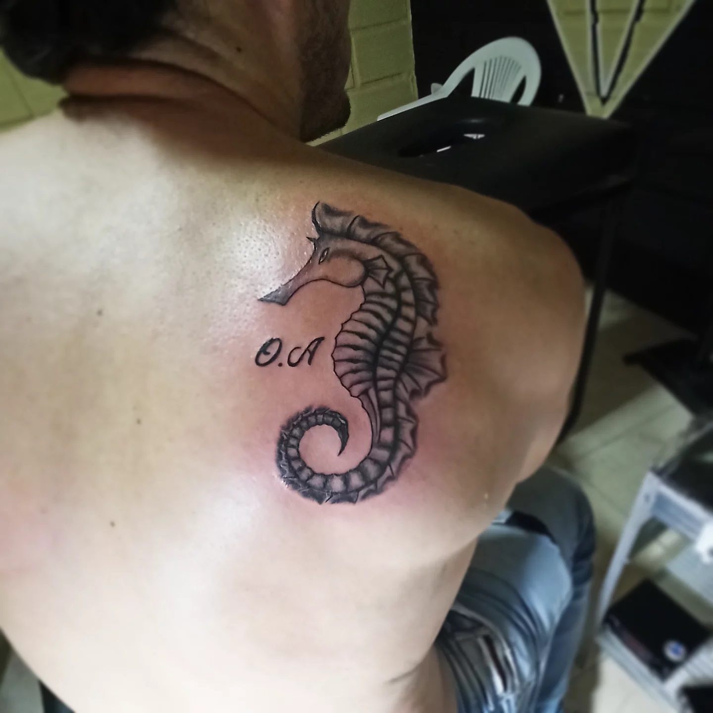 Seahorse black and grey tattoo on the shoulder by Erasmo Vasquez
