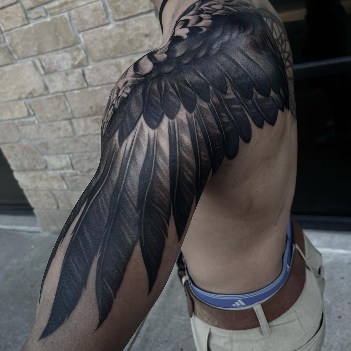 Wing black and grey tattoo on the shoulder by Martin Reyes Jr