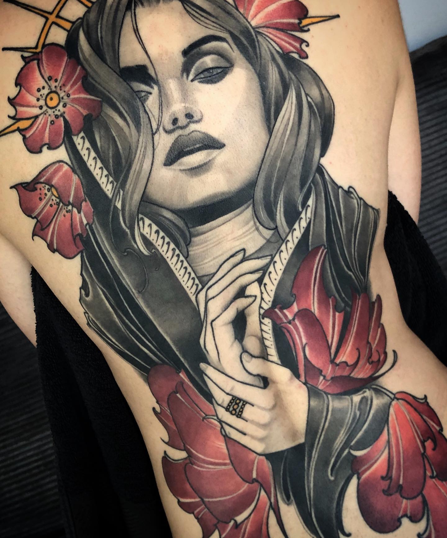 Woman with flowers realism tattoo on the shoulder by Jeff Norton, Atascadero, California