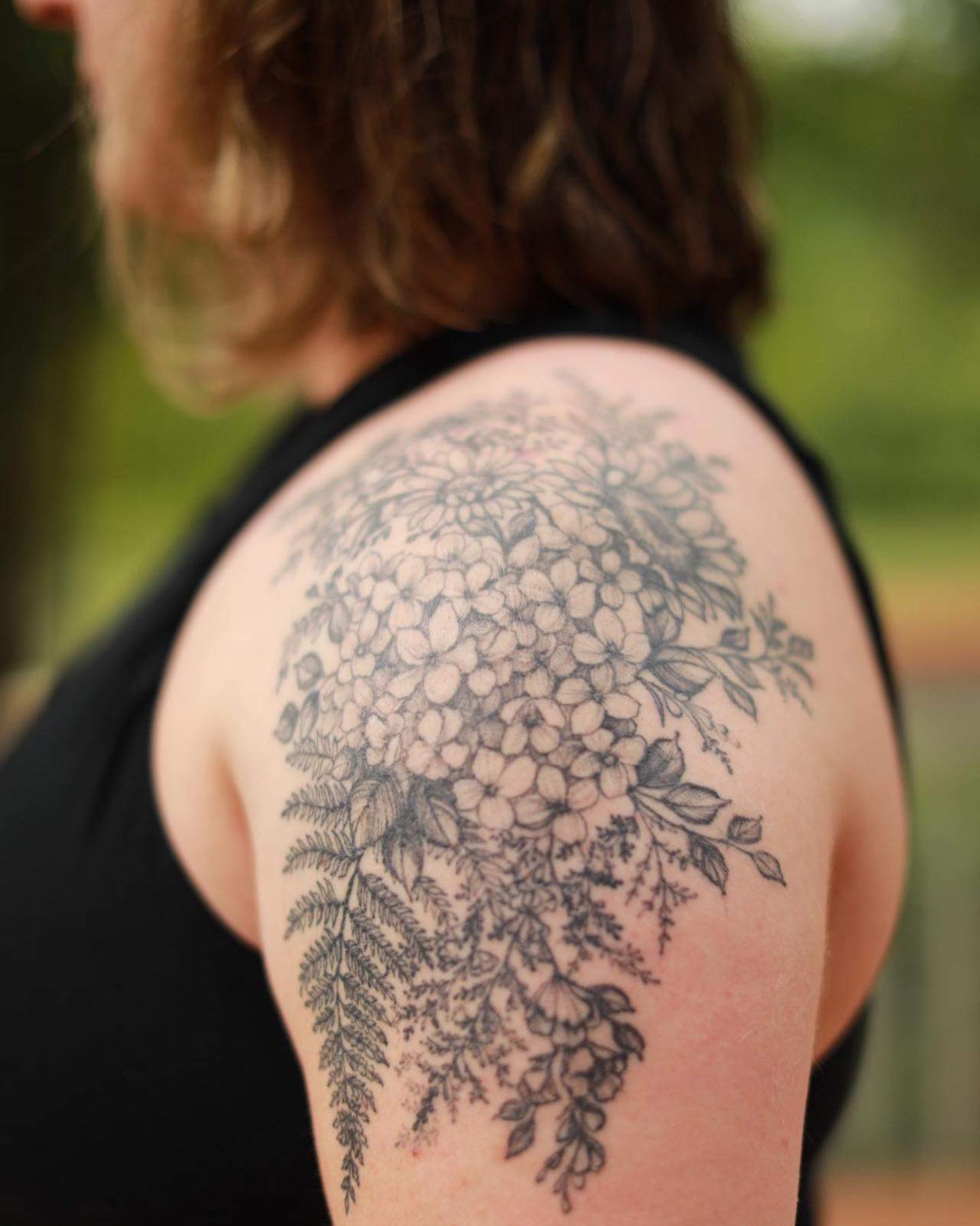 Floral bouquet black and grey tattoo on the shoulder by Sarah Spread