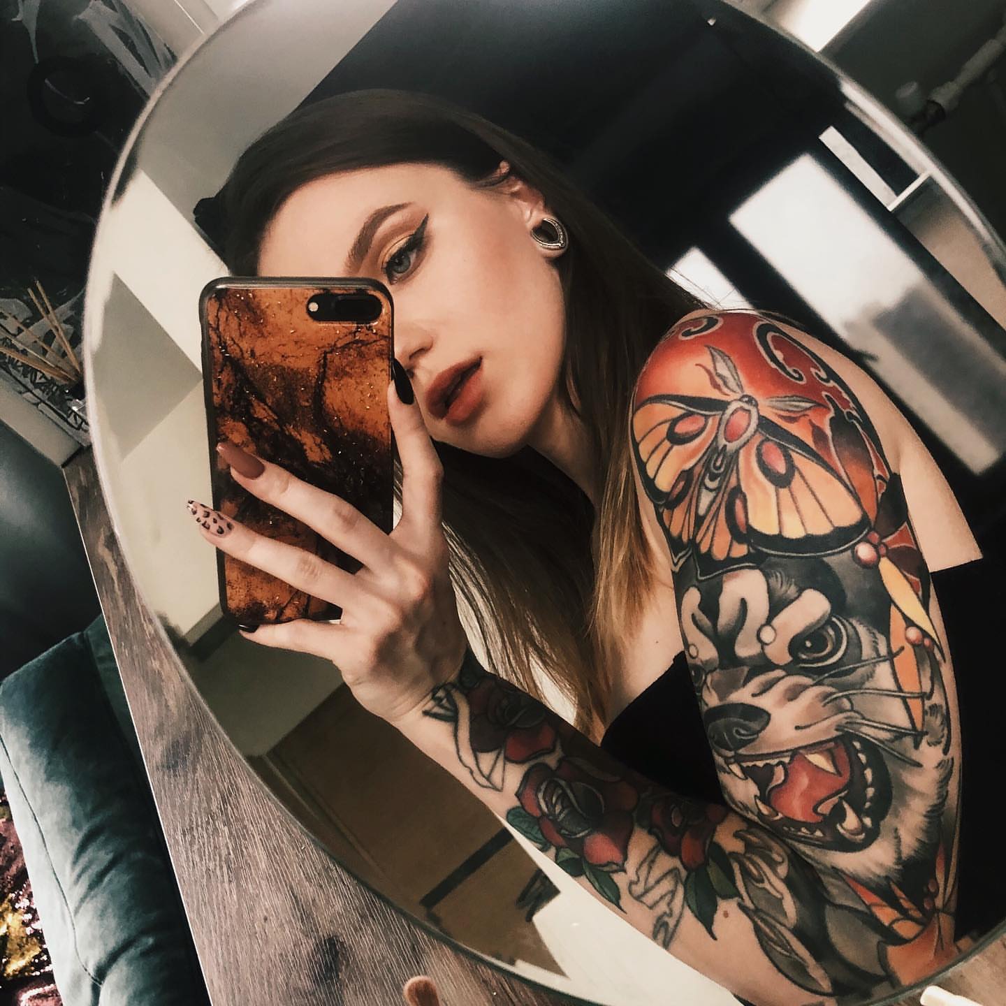 Butterfly and dog American traditional tattoo on the upper arm by Zlata